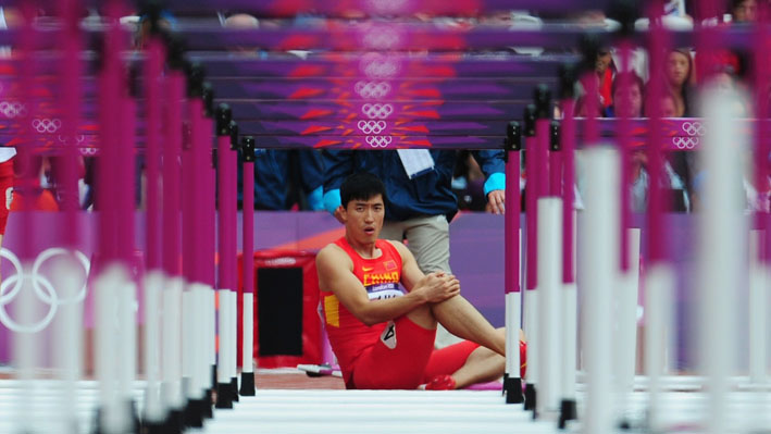 Liu Xiang of China sits on the track