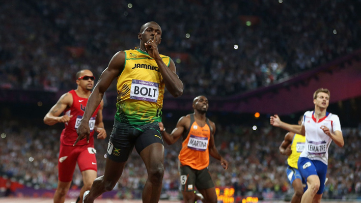 Usain Bolt of Jamaica crosses the finish line to win gold