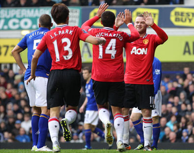 Javier Hernandez celebrates with Ji Sung Park and Wayne Rooney