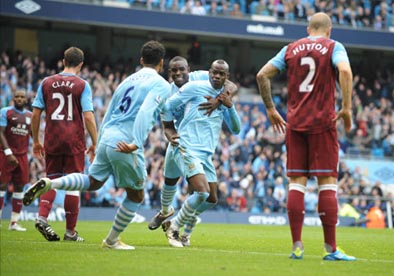 Mario Balotelli celebrates with Micah Richards and Joleon Lescott