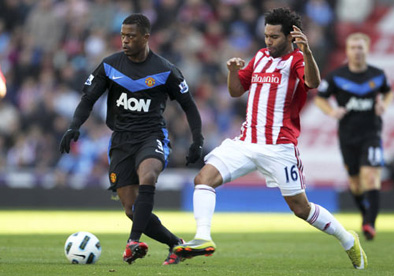 Patrice Evra_ Manchester United gets away from Jermaine Pennant of Stoke City