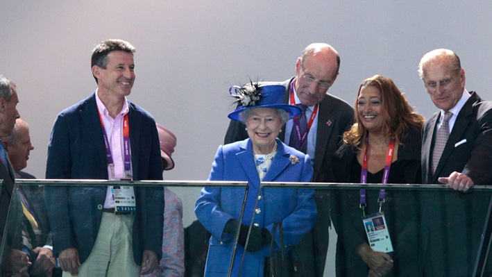 Queen Elizabeth II and Lord Sebastian Coe attend swimming on Day 1