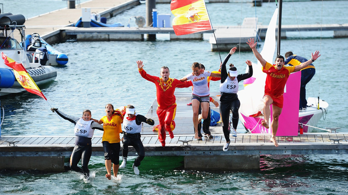 Spain jump into the harbour with team mates as they celebrate winning gold
