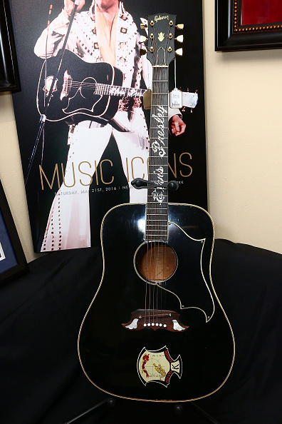NEW YORK, NY - MAY 16: Elvis Presley's 1969 Gibson Dove acoustic guitar is displayed during Julien's Auction Music Icons Press Exhibition at Hard Rock Cafe, Times Square on May 16, 2016 in New York City. (Photo by Astrid Stawiarz/Getty Images)